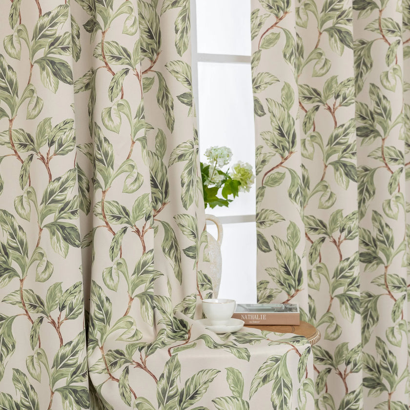 Nature-inspired blackout curtain with lush green leaf prints on a beige background, designed to block sunlight, enhance privacy, and bring a fresh, botanical charm to your living room, bedroom, or dining space.