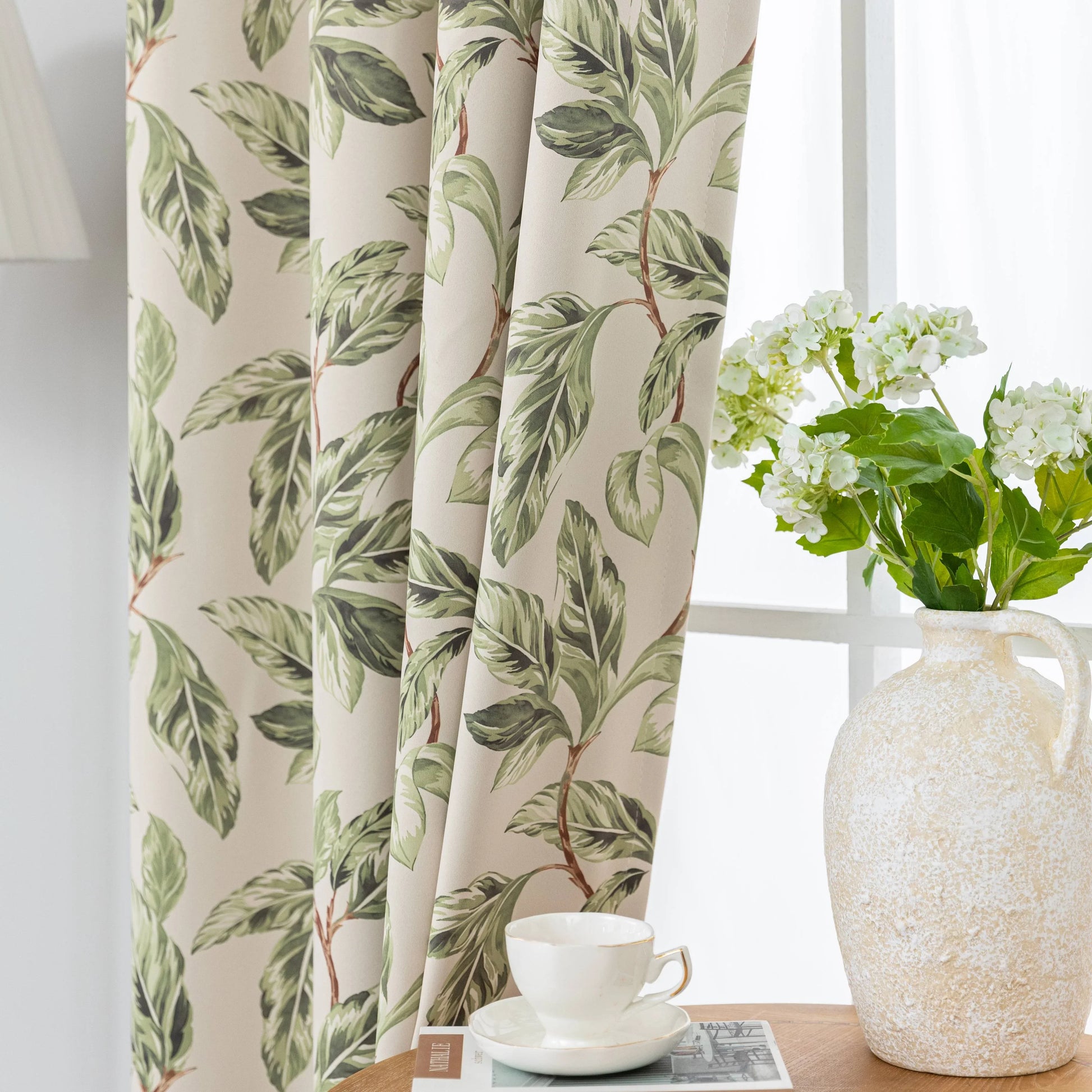 Nature-inspired blackout curtain with lush green leaf prints on a beige background, designed to block sunlight, enhance privacy, and bring a fresh, botanical charm to your living room, bedroom, or dining space.