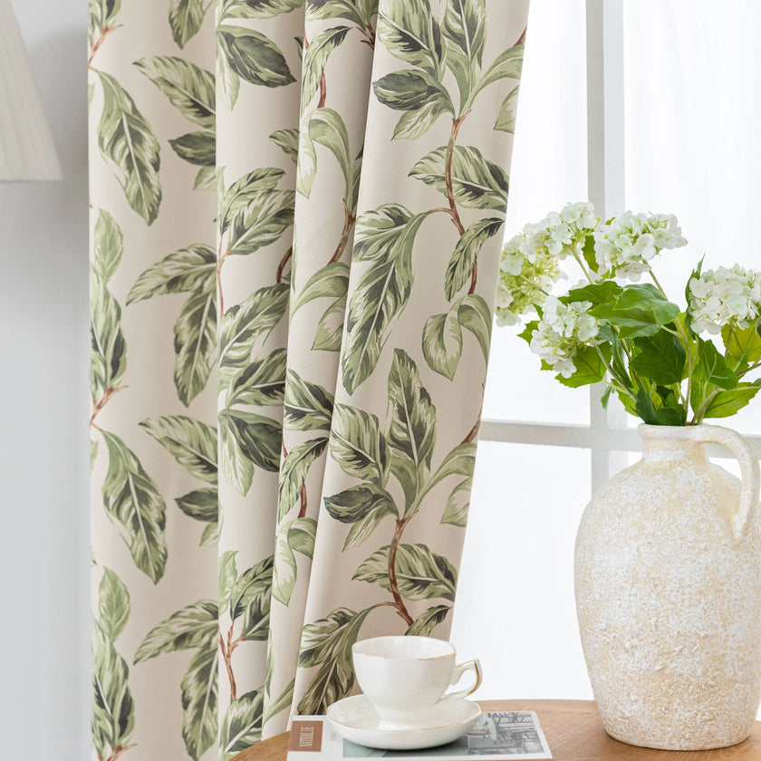 Nature-inspired blackout curtain with lush green leaf prints on a beige background, designed to block sunlight, enhance privacy, and bring a fresh, botanical charm to your living room, bedroom, or dining space.