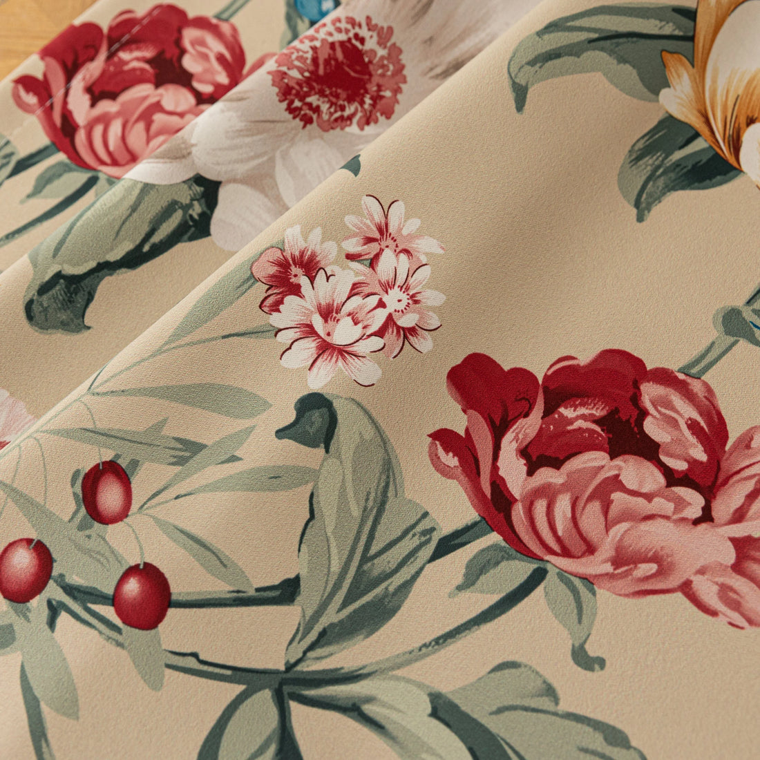 Charming beige blackout curtain with vibrant floral print, featuring yellow, red, and pink blossoms for a fresh, romantic look while providing excellent light blocking and privacy for any room.