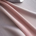 Modern gradient blackout curtain in soft pink and grey tones, offering superior light-blocking and privacy while adding a chic, contemporary touch to your bedroom or living room décor.
