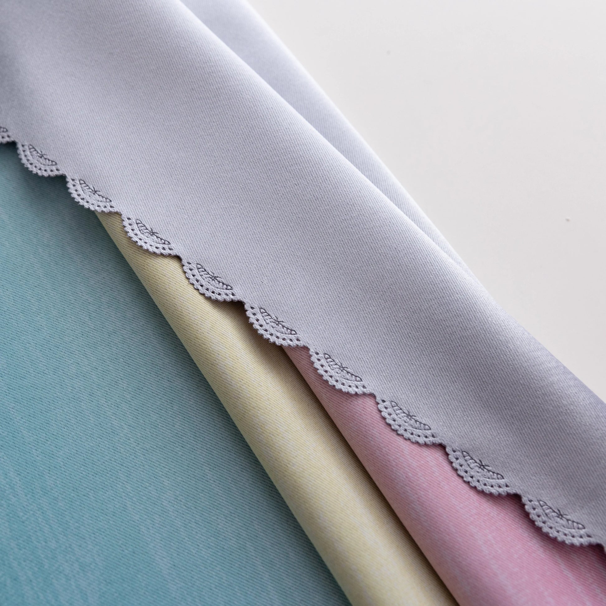 Colorful gradient blackout curtain with soft pink, yellow, and teal hues, designed to block light, enhance privacy, and bring a vibrant, modern charm to any bedroom or living space.