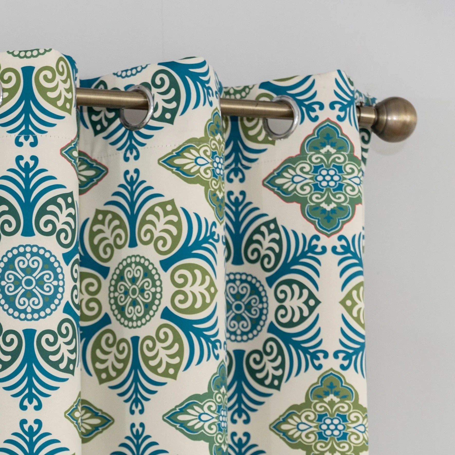 Modern geometric blackout curtain featuring bold teal and green tile-inspired patterns on a cream background, offering stylish decor while blocking sunlight and enhancing privacy.