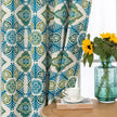 Modern geometric blackout curtain featuring bold teal and green tile-inspired patterns on a cream background, offering stylish decor while blocking sunlight and enhancing privacy.