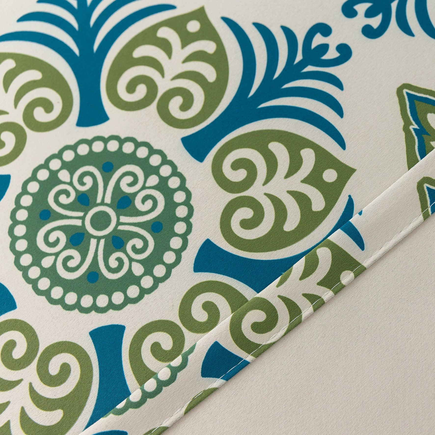 Modern geometric blackout curtain featuring bold teal and green tile-inspired patterns on a cream background, offering stylish decor while blocking sunlight and enhancing privacy.