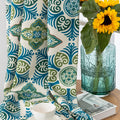 Modern geometric blackout curtain featuring bold teal and green tile-inspired patterns on a cream background, offering stylish decor while blocking sunlight and enhancing privacy.