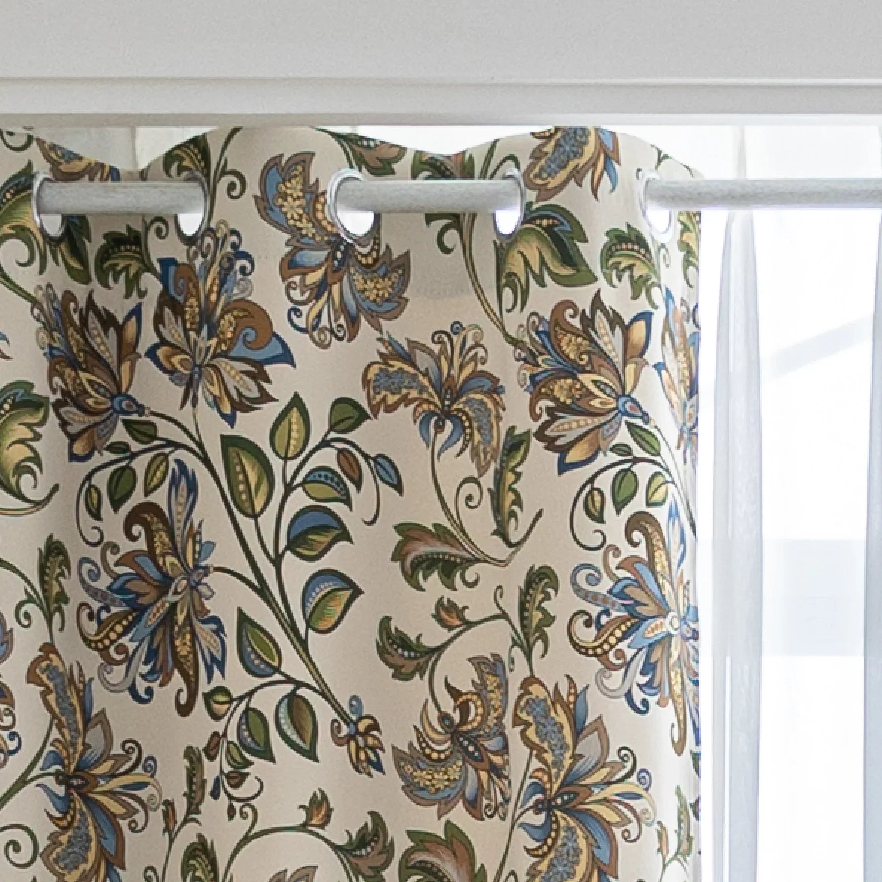 Elegant floral blackout curtain featuring intricate blue, green, and gold leaf patterns on a cream background, perfect for adding classic charm while effectively blocking light and ensuring privacy.