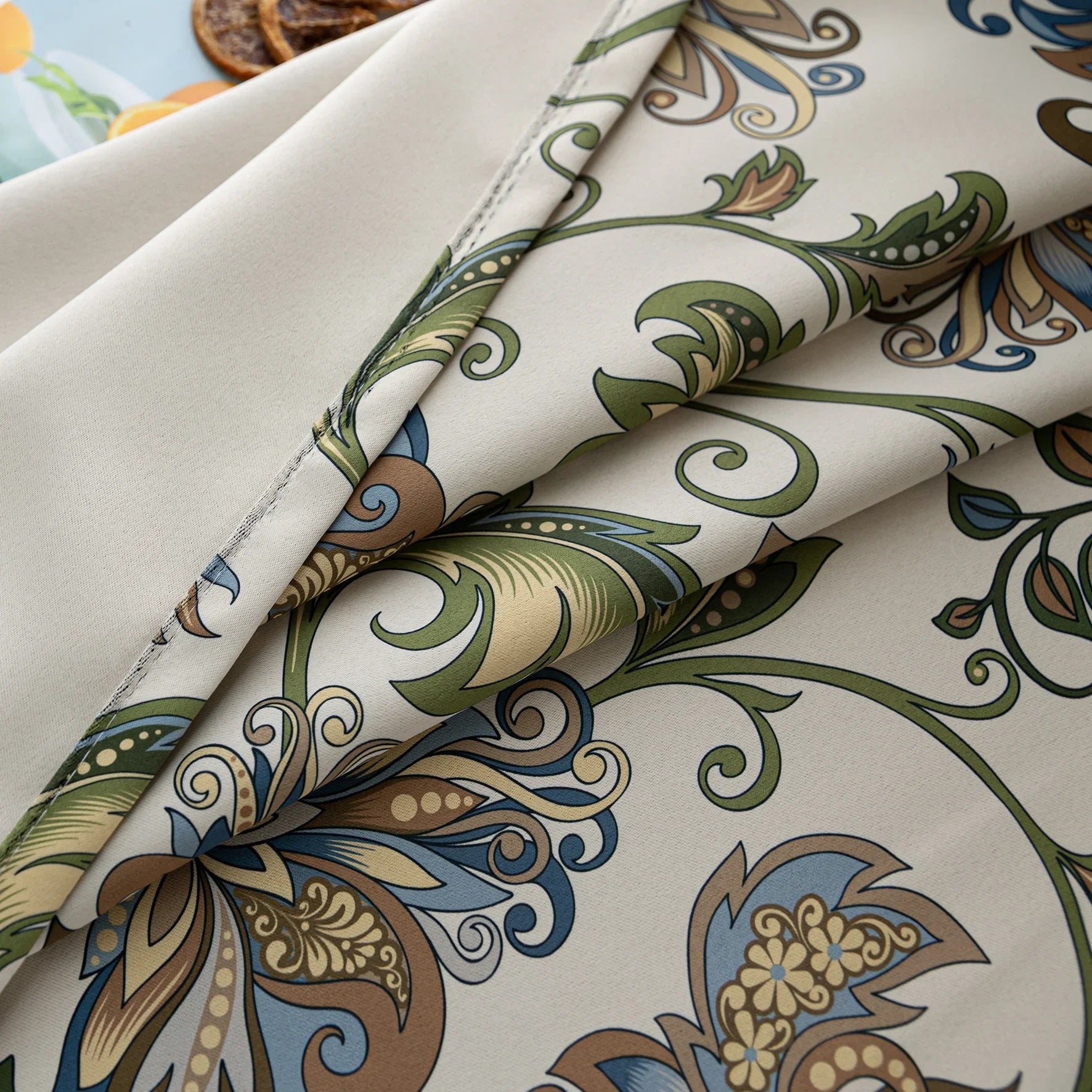 Elegant floral blackout curtain featuring intricate blue, green, and gold leaf patterns on a cream background, perfect for adding classic charm while effectively blocking light and ensuring privacy.