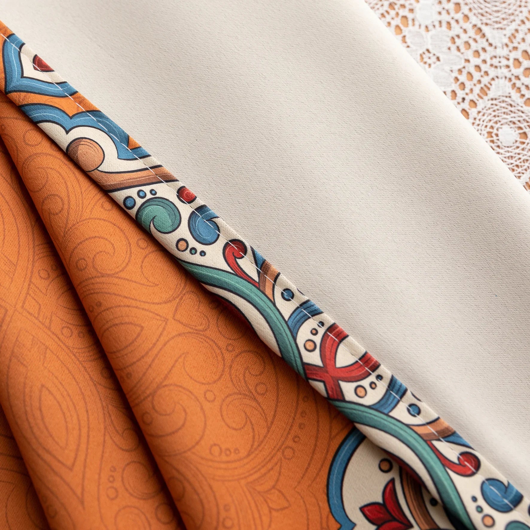 Stylish burnt orange blackout curtain with intricate medallion border design, blending vibrant color with elegant patterns to provide privacy, block sunlight, and enhance any living or bedroom décor.