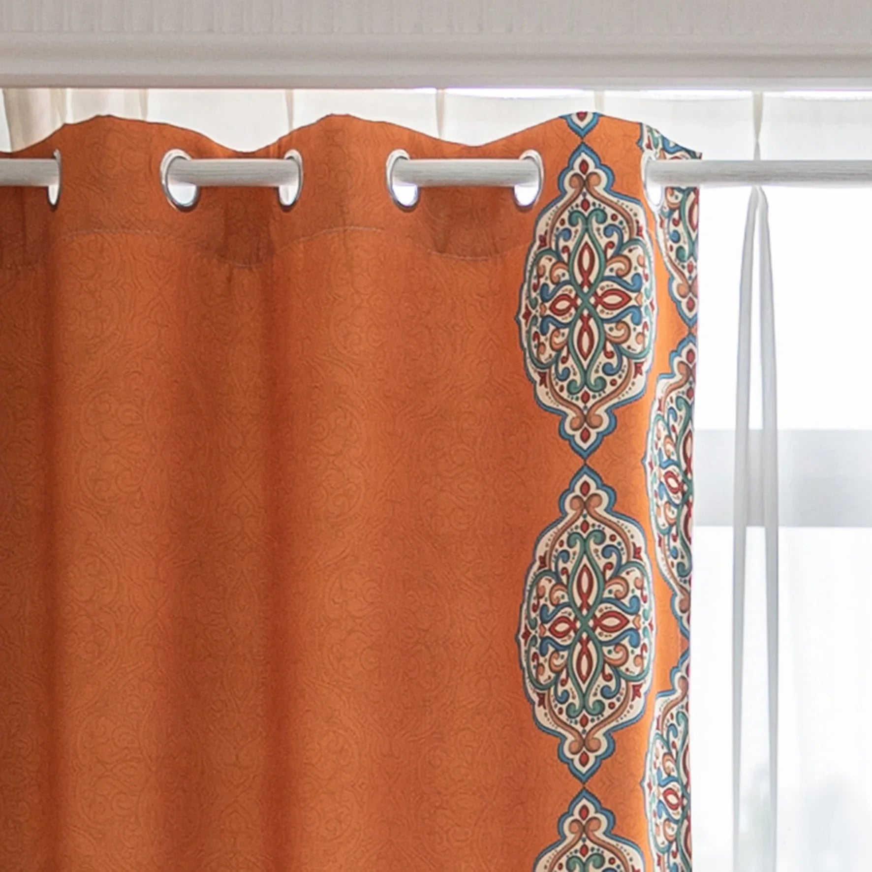 Stylish burnt orange blackout curtain with intricate medallion border design, blending vibrant color with elegant patterns to provide privacy, block sunlight, and enhance any living or bedroom décor.