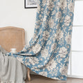 Elegant floral blackout curtain featuring soft cream blossoms on a serene blue background, combining classic botanical charm with effective light-blocking for a cozy and stylish living space.