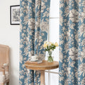 Elegant floral blackout curtain featuring soft cream blossoms on a serene blue background, combining classic botanical charm with effective light-blocking for a cozy and stylish living space.