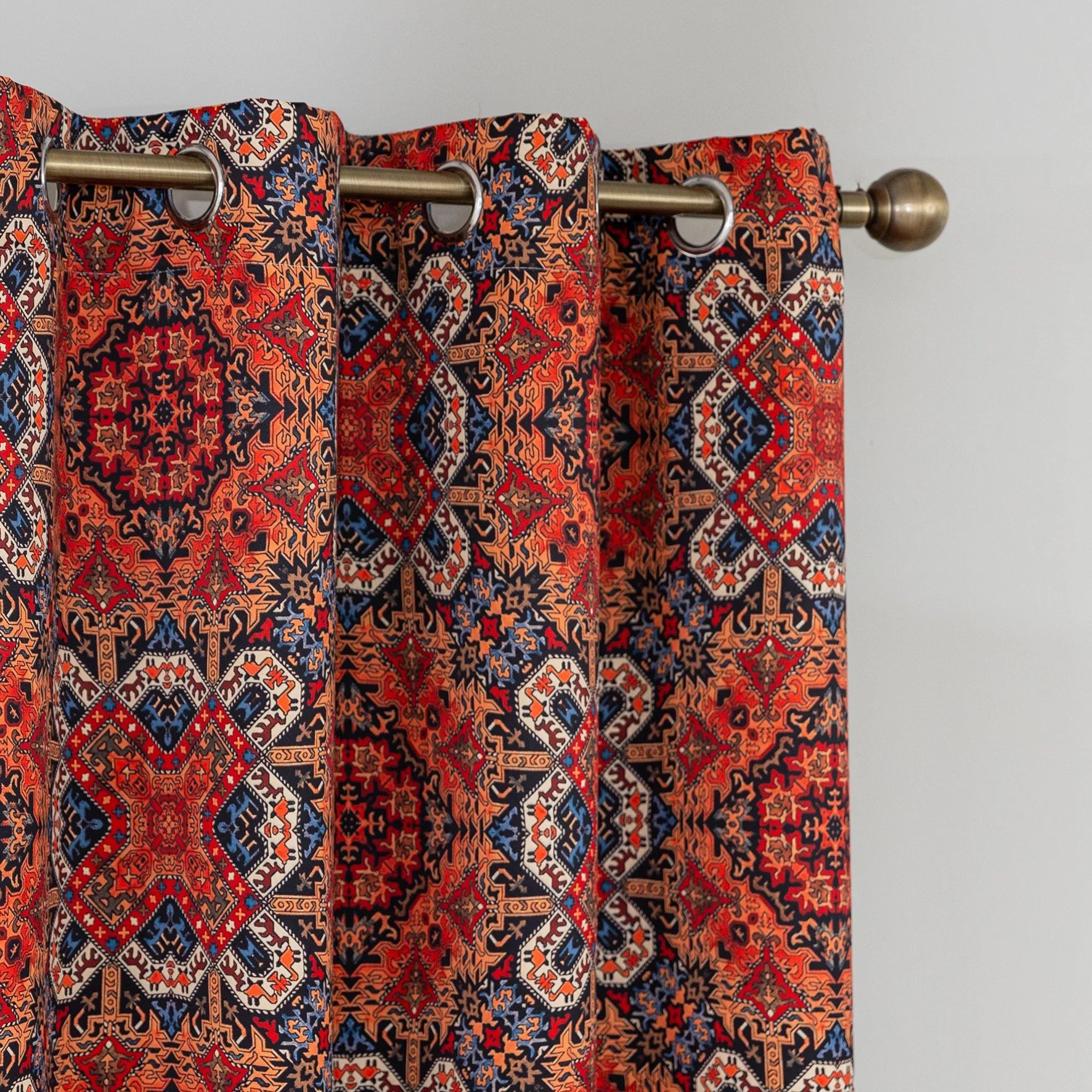 Persian-inspired blackout curtain featuring rich red, navy, and gold tones in an intricate geometric pattern, offering both timeless elegance and effective light-blocking for a warm, stylish home.