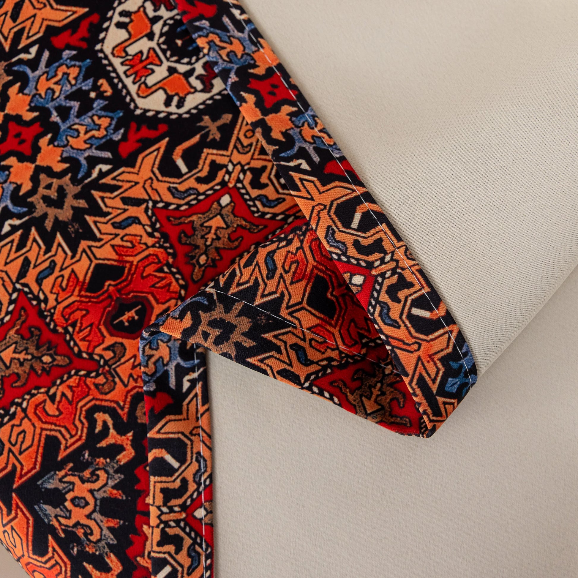 Persian-inspired blackout curtain featuring rich red, navy, and gold tones in an intricate geometric pattern, offering both timeless elegance and effective light-blocking for a warm, stylish home.