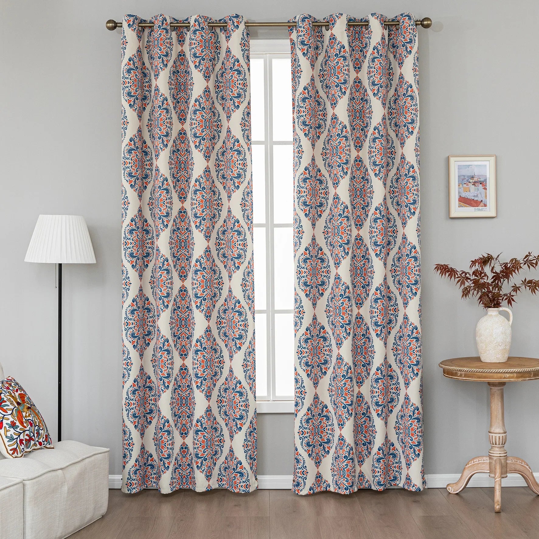 Elegant blackout curtain with blue and orange damask patterns on a cream background, offering stylish light-blocking and privacy for any room.