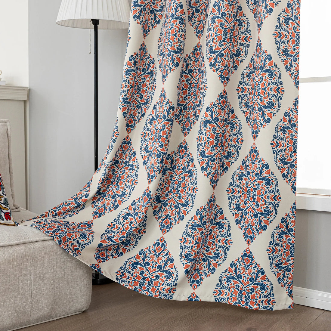 Elegant blackout curtain with blue and orange damask patterns on a cream background, offering stylish light-blocking and privacy for any room.