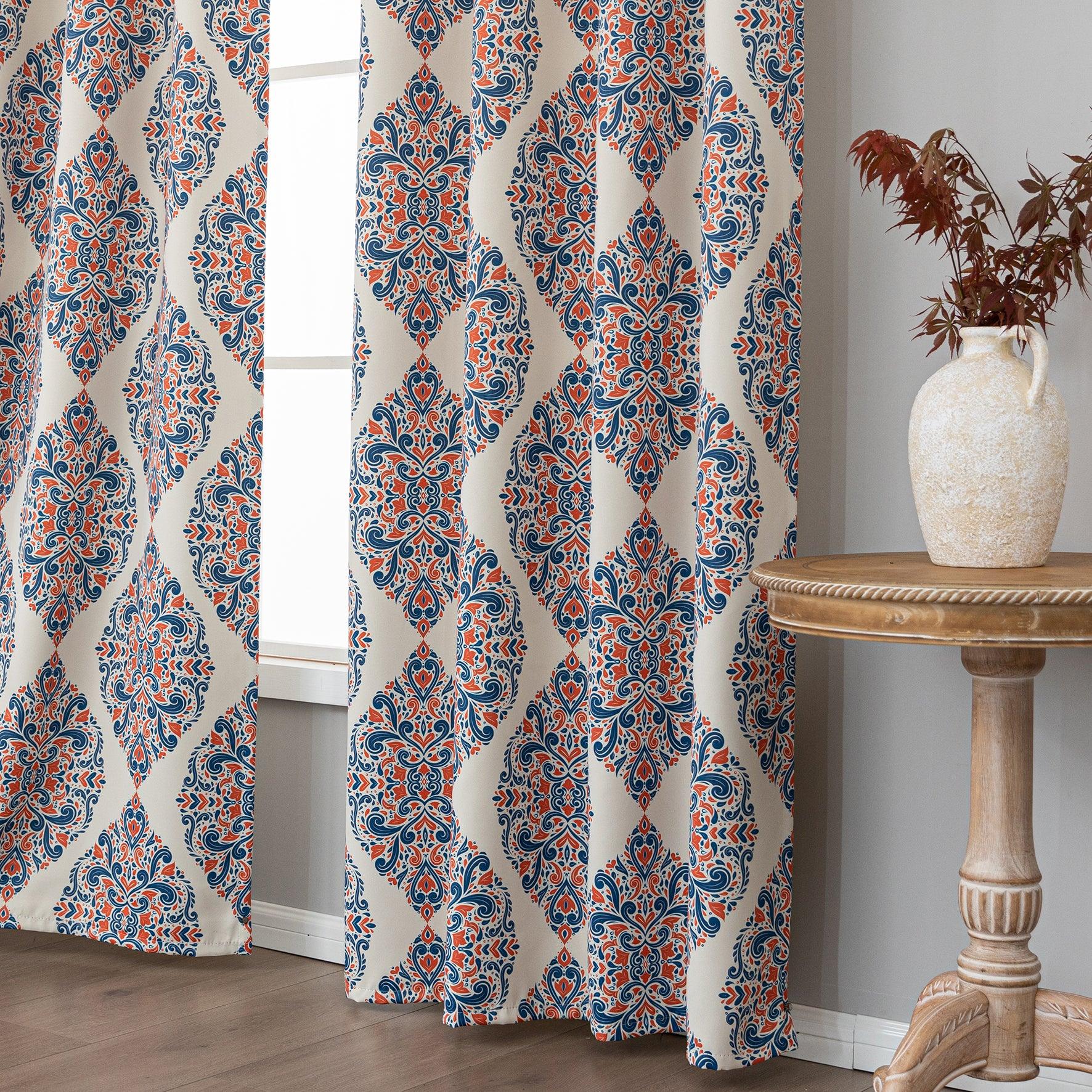 Elegant blackout curtain with blue and orange damask patterns on a cream background, offering stylish light-blocking and privacy for any room.