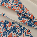 Elegant blackout curtain with blue and orange damask patterns on a cream background, offering stylish light-blocking and privacy for any room.