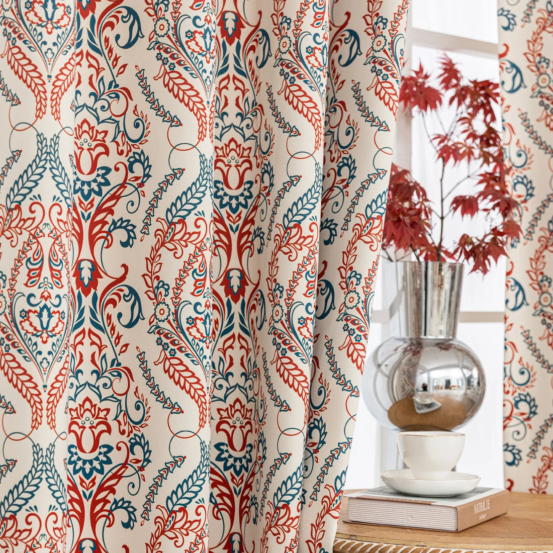 Elegant bohemian blackout curtain with intricate red and teal floral patterns on a soft beige background, designed to block sunlight, reduce noise, and add artistic charm to any room.