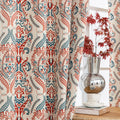 Elegant bohemian blackout curtain with intricate red and teal floral patterns on a soft beige background, designed to block sunlight, reduce noise, and add artistic charm to any room.