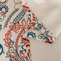 Elegant bohemian blackout curtain with intricate red and teal floral patterns on a soft beige background, designed to block sunlight, reduce noise, and add artistic charm to any room.