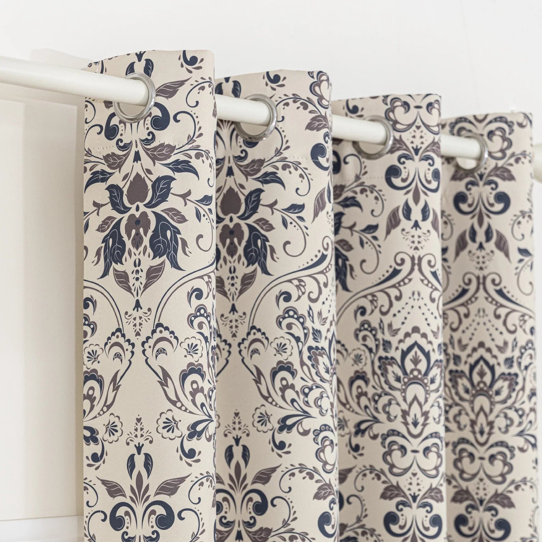 Stylish blackout curtain with an elegant dark floral damask pattern on a neutral beige background, offering excellent light-blocking, privacy, and a timeless touch for modern and classic interiors.