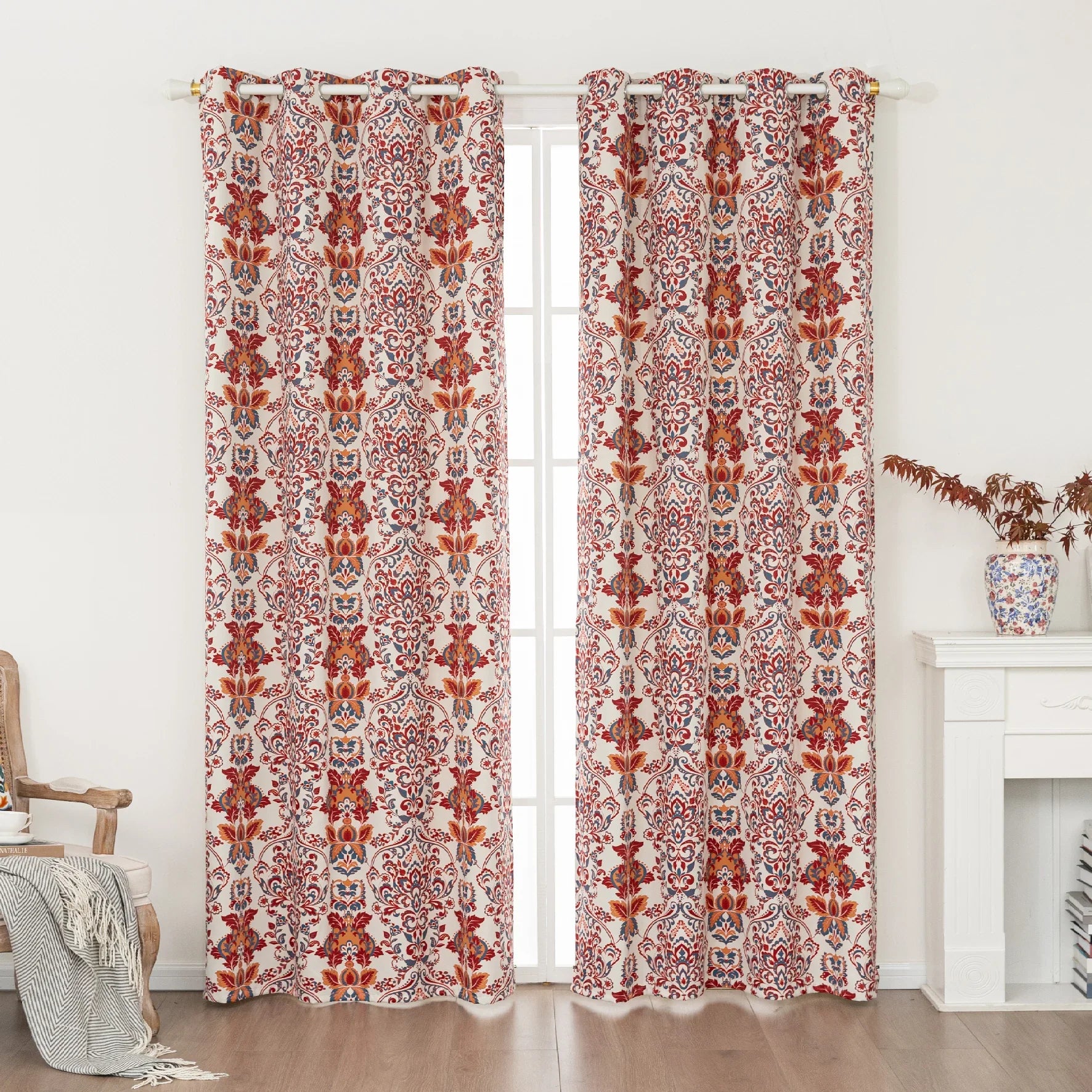 Vibrant blackout curtain featuring an intricate red, orange, and blue damask floral pattern on a soft cream background, designed to block light, enhance privacy, and add a bold, elegant touch to any room décor.