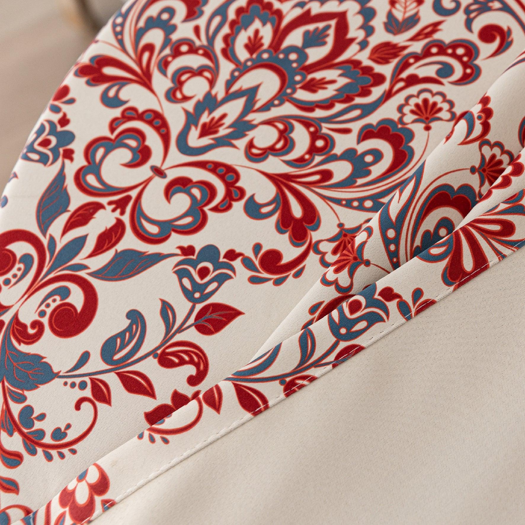 Vibrant blackout curtain featuring an intricate red, orange, and blue damask floral pattern on a soft cream background, designed to block light, enhance privacy, and add a bold, elegant touch to any room décor.