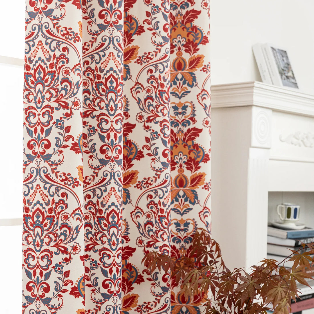 Vibrant blackout curtain featuring an intricate red, orange, and blue damask floral pattern on a soft cream background, designed to block light, enhance privacy, and add a bold, elegant touch to any room décor.