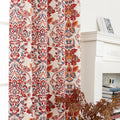 Vibrant blackout curtain featuring an intricate red, orange, and blue damask floral pattern on a soft cream background, designed to block light, enhance privacy, and add a bold, elegant touch to any room décor.
