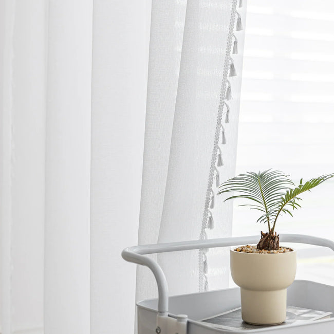 White Sheer Curtains with Pom Pom Trim ¨C Create an airy, elegant atmosphere with these lightweight white sheer curtains, featuring delicate pom pom edging for a subtle decorative touch. Perfect for softening natural light while maintaining privacy, they add a fresh and cozy feel to bedrooms, living rooms, or reading nooks. Easy to pair with any d¨¦cor style, these breathable and stylish curtains enhance your space with effortless charm.

