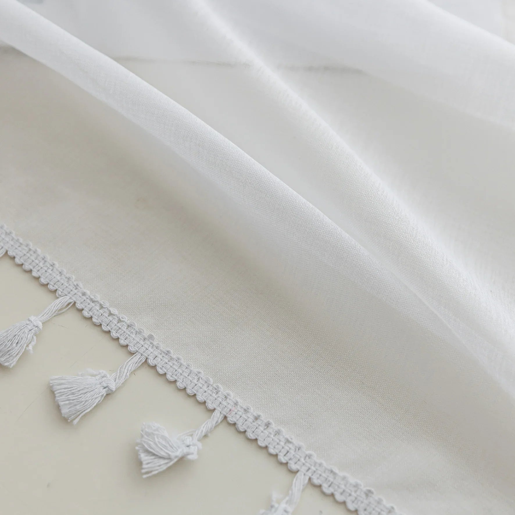 White Sheer Curtains with Pom Pom Trim – Create an airy, elegant atmosphere with these lightweight white sheer curtains, featuring delicate pom pom edging for a subtle decorative touch. Perfect for softening natural light while maintaining privacy, they add a fresh and cozy feel to bedrooms, living rooms, or reading nooks. Easy to pair with any décor style, these breathable and stylish curtains enhance your space with effortless charm.
