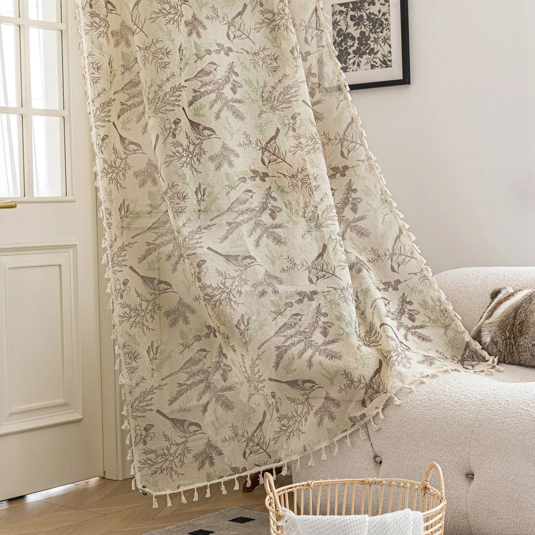 Beige curtain with delicate bird and botanical print in soft brown and green tones, finished with tassel trim, adding a rustic and nature-inspired charm to living room décor.
