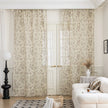 Sheer beige curtains with delicate bird and botanical print in soft brown and green hues, creating an airy, nature-inspired look for French doors in a cozy living room.