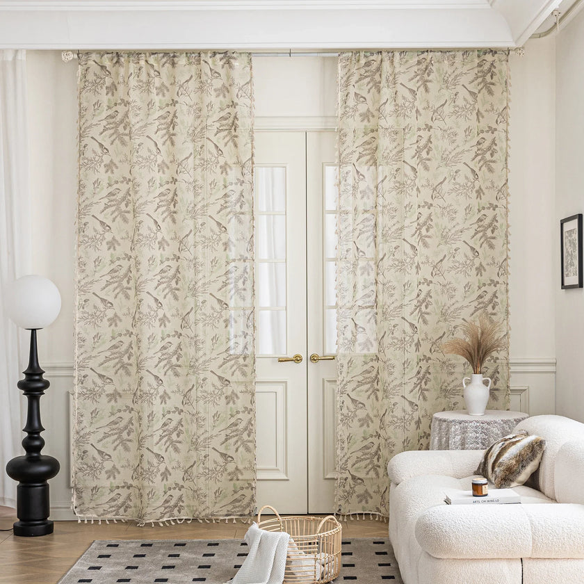Sheer beige curtains with delicate bird and botanical print in soft brown and green hues, creating an airy, nature-inspired look for French doors in a cozy living room.