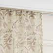 beige linen curtain fabric with brown and green botanical and bird print, featuring decorative tassel trim