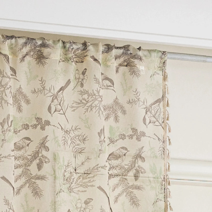beige linen curtain fabric with brown and green botanical and bird print, featuring decorative tassel trim