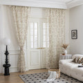 beige linen curtain fabric with brown and green botanical and bird print, featuring decorative tassel trim