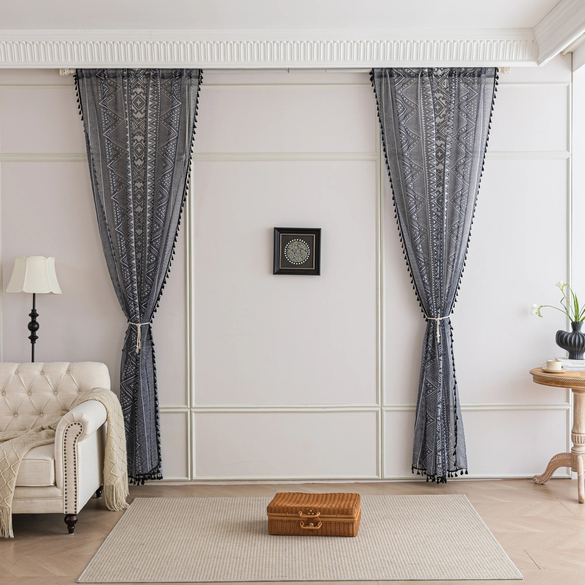 Modern Black and White Geometric Sheer Curtains – Enhance your home with these contemporary sheer curtains featuring an intricate tribal-inspired geometric pattern in black and white. The lightweight fabric allows natural light to filter through while maintaining a sense of privacy, making them perfect for living rooms, bedrooms, or minimalist interiors. Finished with delicate black tassels along the edges, these curtains add a stylish yet subtle decorative touch that complements modern, boho, or Scandinavi