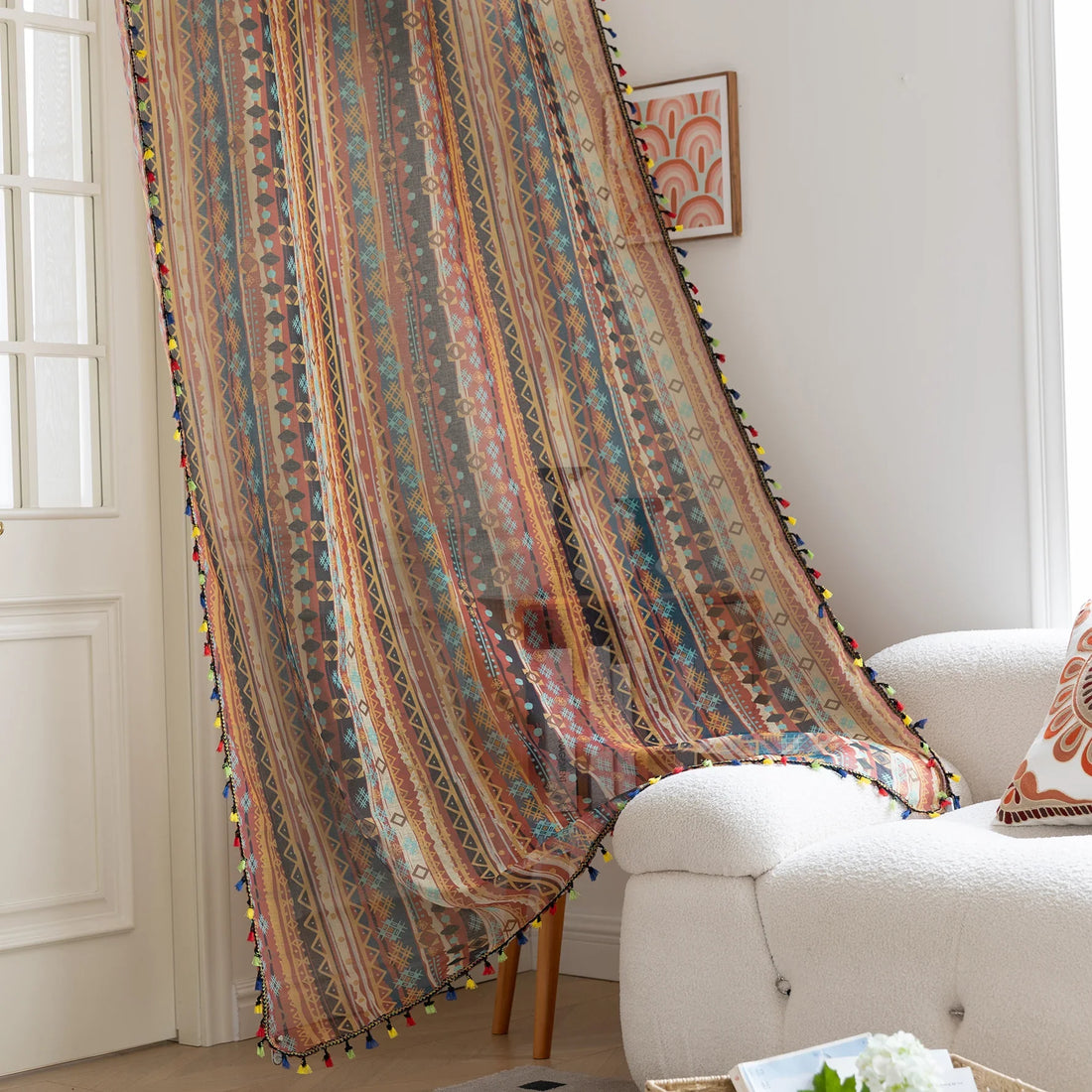 Bring warmth and character to your space with this bohemian tribal-patterned sheer curtain, featuring rich earth tones, geometric motifs, and colorful tassel trim. Crafted from lightweight, breathable fabric, it softly filters sunlight to create a cozy and inviting ambiance while maintaining privacy.