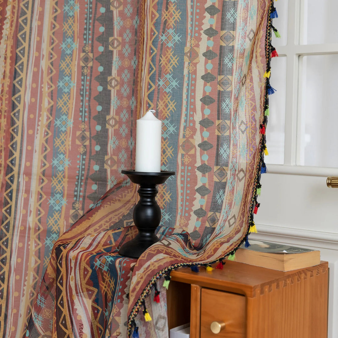 Bring warmth and character to your space with this bohemian tribal-patterned sheer curtain, featuring rich earth tones, geometric motifs, and colorful tassel trim. Crafted from lightweight, breathable fabric, it softly filters sunlight to create a cozy and inviting ambiance while maintaining privacy.