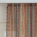 Bring warmth and character to your space with this bohemian tribal-patterned sheer curtain, featuring rich earth tones, geometric motifs, and colorful tassel trim. Crafted from lightweight, breathable fabric, it softly filters sunlight to create a cozy and inviting ambiance while maintaining privacy.