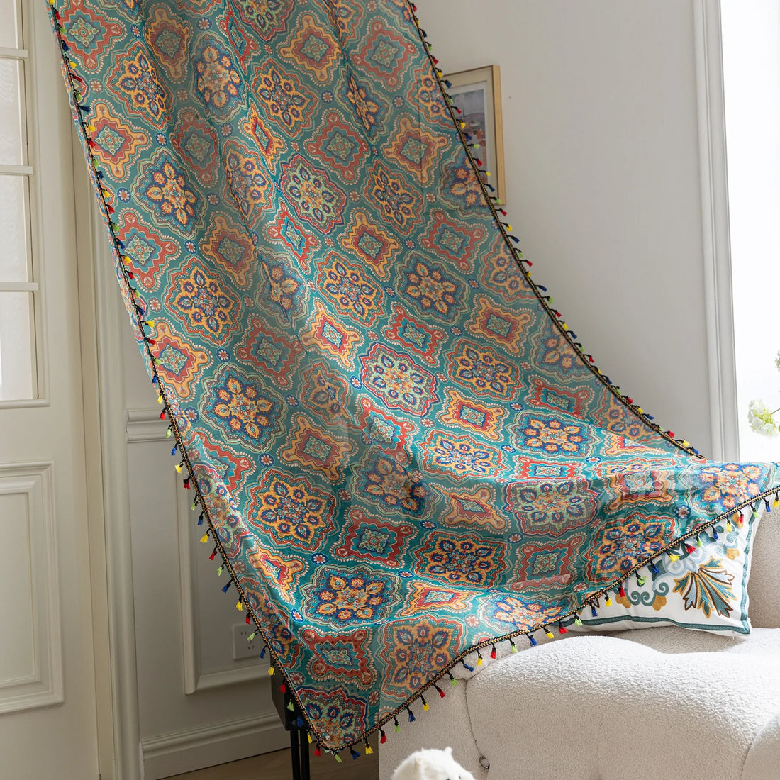 Bohemian Moroccan Print Sheer Curtains – Infuse your home with vibrant charm using these colorful sheer curtains featuring intricate Moroccan-inspired patterns in teal, orange, yellow, and red. Crafted from lightweight fabric, they allow soft light to filter through while adding a burst of personality to your space. Finished with playful multicolor tassel trim, these curtains are perfect for creating a cozy boho vibe in living rooms, bedrooms, or creative studios.
