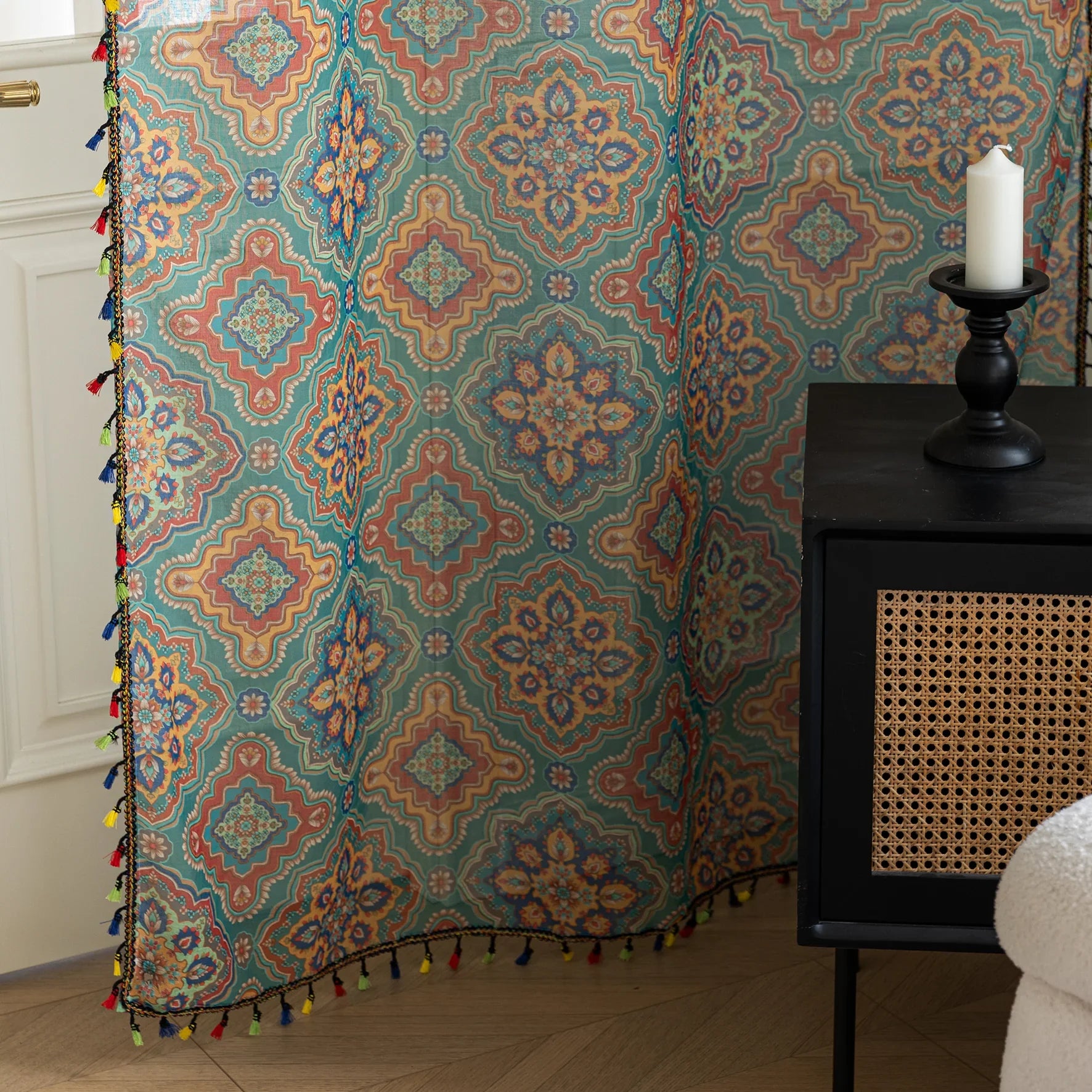 Bring vibrant elegance to your home with this bohemian-style sheer curtain, featuring an intricate geometric pattern in rich teal, orange, and gold tones. Crafted from lightweight, breathable fabric, it allows natural light to filter through while maintaining privacy. Perfect for living rooms, bedrooms, or creative spaces, this decorative curtain adds warmth and personality to any interior. The colorful tassel trim enhances its artisanal charm, making it a versatile choice for both modern and eclectic home 