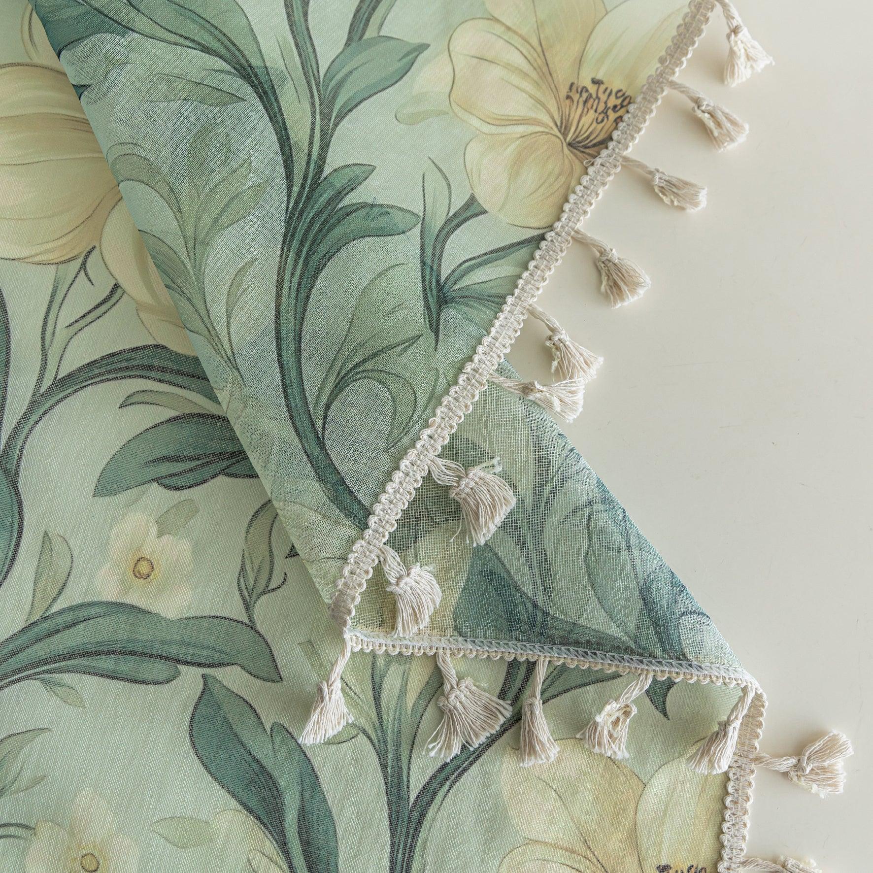 Floral Sheer Curtains with Green Leaves and Cream Blossoms – Bring the beauty of nature indoors with these elegant sheer curtains featuring a delicate pattern of lush green foliage and soft cream flowers. The airy, lightweight fabric allows natural light to filter through while adding a touch of privacy. Finished with charming tassel trim, these curtains are perfect for brightening living rooms, bedrooms, or garden-inspired spaces, creating a fresh and inviting atmosphere.
