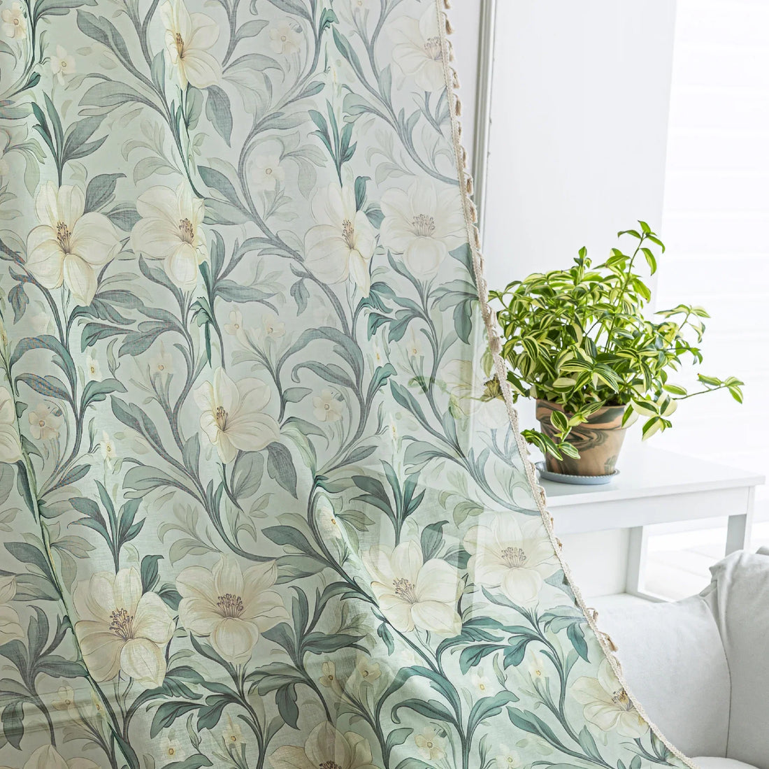 Floral Sheer Curtains with Green Leaves and Cream Blossoms – Bring the beauty of nature indoors with these elegant sheer curtains featuring a delicate pattern of lush green foliage and soft cream flowers. The airy, lightweight fabric allows natural light to filter through while adding a touch of privacy. Finished with charming tassel trim, these curtains are perfect for brightening living rooms, bedrooms, or garden-inspired spaces, creating a fresh and inviting atmosphere.
