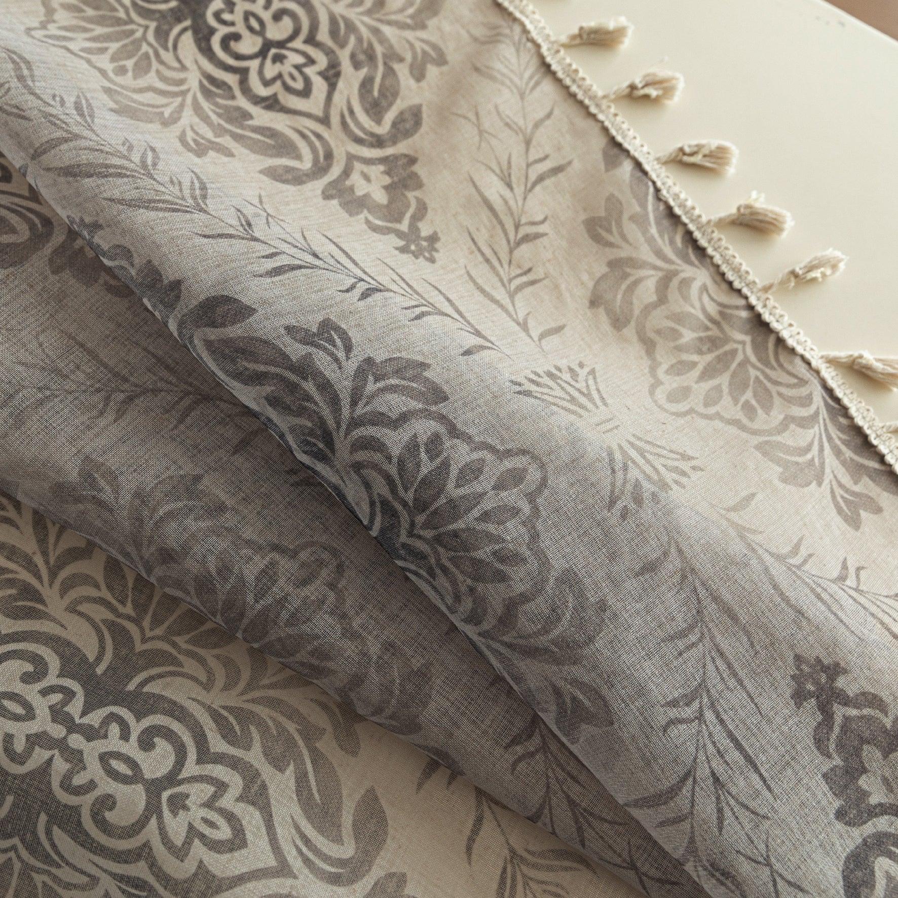 Elegant Beige and Grey Floral Sheer Curtains – Add a touch of timeless charm to your home with these delicate sheer curtains featuring an intricate floral damask pattern in soft grey tones on a warm beige background. Designed to gently filter sunlight while maintaining privacy, these lightweight curtains create an airy and inviting atmosphere, perfect for living rooms, bedrooms, or vintage-inspired interiors. Finished with subtle tassel edging for an extra hint of sophistication.
