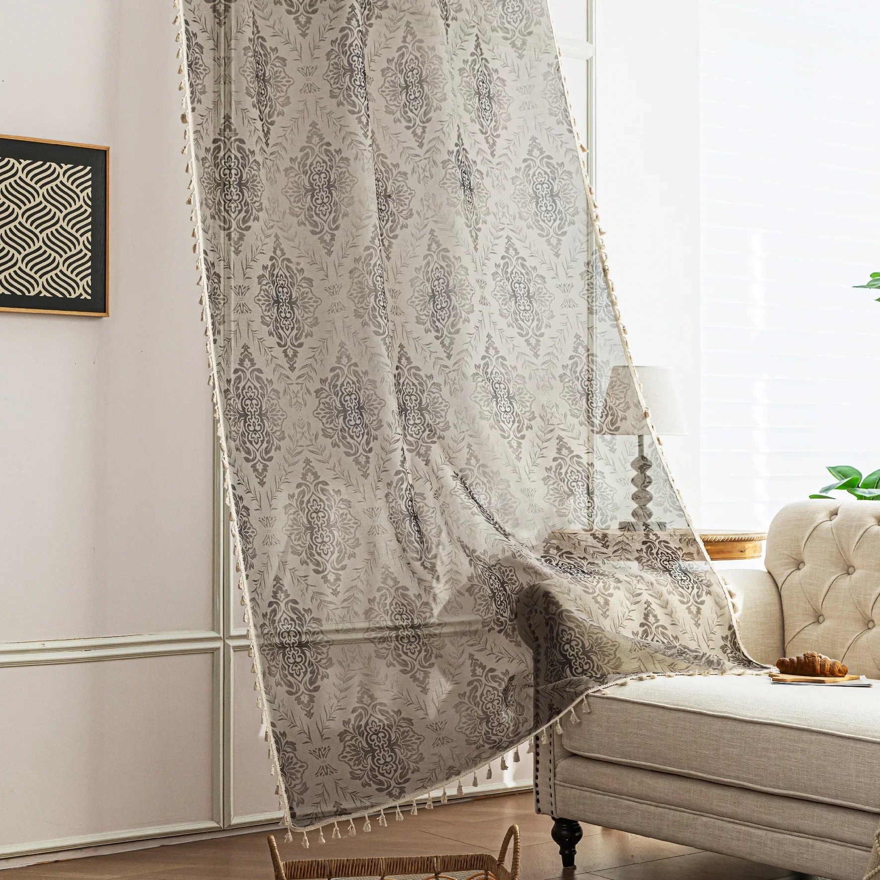 Elegant Beige and Grey Floral Sheer Curtains – Add a touch of timeless charm to your home with these delicate sheer curtains featuring an intricate floral damask pattern in soft grey tones on a warm beige background. Designed to gently filter sunlight while maintaining privacy, these lightweight curtains create an airy and inviting atmosphere, perfect for living rooms, bedrooms, or vintage-inspired interiors. Finished with subtle tassel edging for an extra hint of sophistication.
