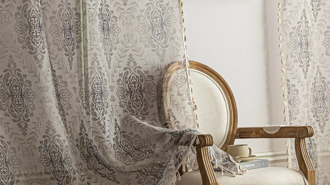 Elegant Beige and Grey Floral Sheer Curtains ¨C Add a touch of timeless charm to your home with these delicate sheer curtains featuring an intricate floral damask pattern in soft grey tones on a warm beige background. Designed to gently filter sunlight while maintaining privacy, these lightweight curtains create an airy and inviting atmosphere, perfect for living rooms, bedrooms, or vintage-inspired interiors. Finished with subtle tassel edging for an extra hint of sophistication.
