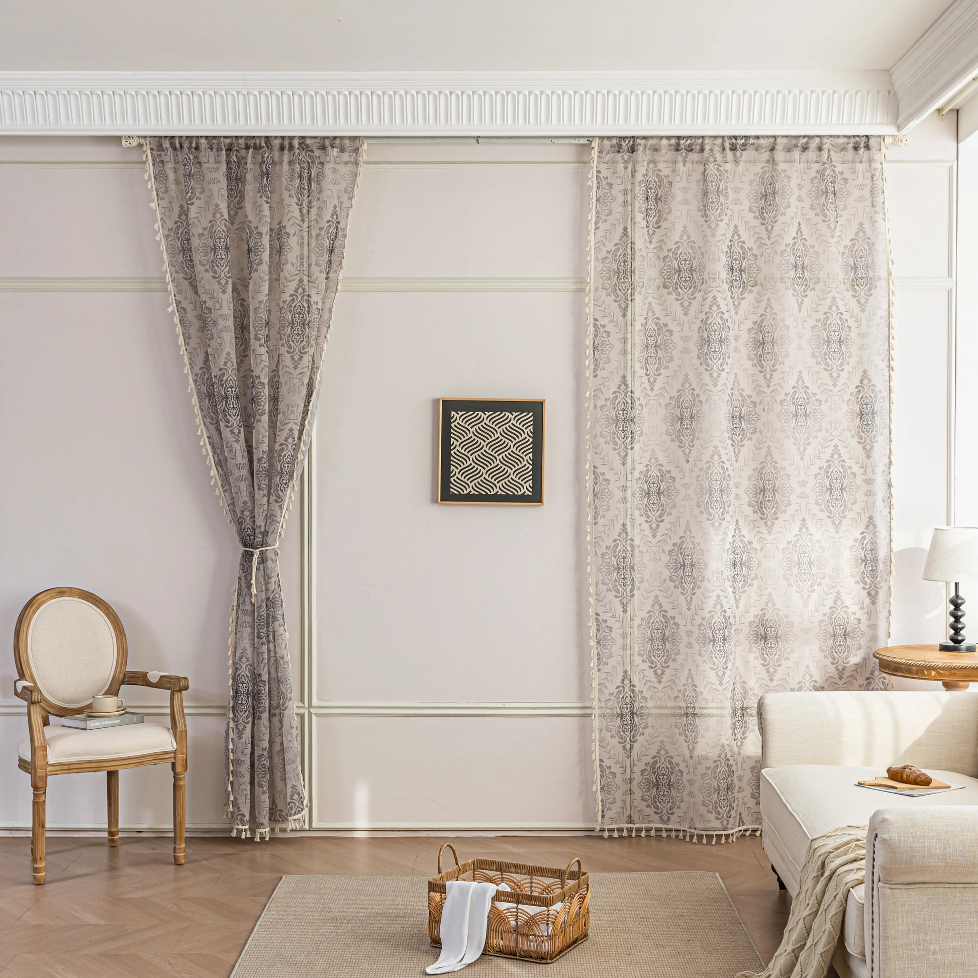 Elegant Beige and Grey Floral Sheer Curtains – Add a touch of timeless charm to your home with these delicate sheer curtains featuring an intricate floral damask pattern in soft grey tones on a warm beige background. Designed to gently filter sunlight while maintaining privacy, these lightweight curtains create an airy and inviting atmosphere, perfect for living rooms, bedrooms, or vintage-inspired interiors. Finished with subtle tassel edging for an extra hint of sophistication.
